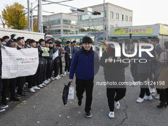 Nov 14, 2019 - Sangju, South Korea-A Group of High Schoolers cheer up for their senior group at entrance gate of Sangju high school in Sangj...