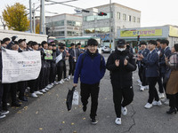 Nov 14, 2019 - Sangju, South Korea-A Group of High Schoolers cheer up for their senior group at entrance gate of Sangju high school in Sangj...