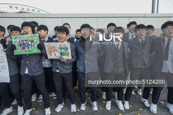 Nov 14, 2019 - Sangju, South Korea-A Group of High Schoolers cheer up for their senior group at entrance gate of Sangju high school in Sangj...