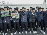 Nov 14, 2019 - Sangju, South Korea-A Group of High Schoolers cheer up for their senior group at entrance gate of Sangju high school in Sangj...