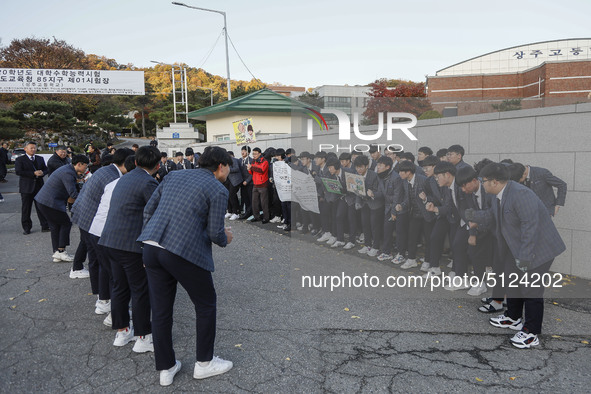 Nov 14, 2019 - Sangju, South Korea-A Group of High Schoolers cheer up for their senior group at entrance gate of Sangju high school in Sangj...