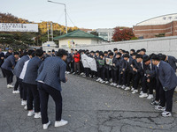 Nov 14, 2019 - Sangju, South Korea-A Group of High Schoolers cheer up for their senior group at entrance gate of Sangju high school in Sangj...