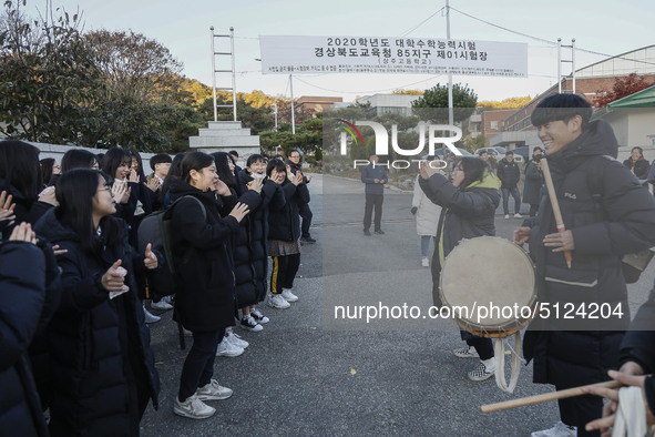 Nov 14, 2019 - Sangju, South Korea-A Group of High Schoolers cheer up for their senior group at entrance gate of Sangju high school in Sangj...