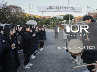 Nov 14, 2019 - Sangju, South Korea-A Group of High Schoolers cheer up for their senior group at entrance gate of Sangju high school in Sangj...