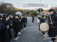 Nov 14, 2019 - Sangju, South Korea-A Group of High Schoolers cheer up for their senior group at entrance gate of Sangju high school in Sangj...