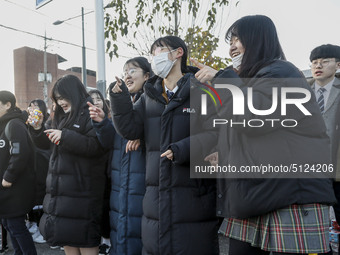 Nov 14, 2019 - Sangju, South Korea-A Group of High Schoolers cheer up for their senior group at entrance gate of Sangju high school in Sangj...