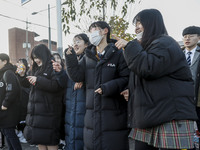 Nov 14, 2019 - Sangju, South Korea-A Group of High Schoolers cheer up for their senior group at entrance gate of Sangju high school in Sangj...