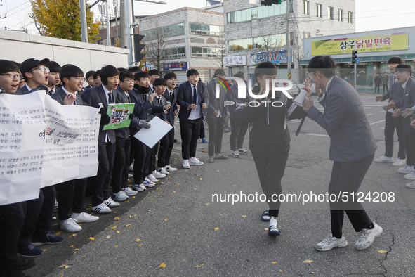 Nov 14, 2019 - Sangju, South Korea-A Group of High Schoolers cheer up for their senior group at entrance gate of Sangju high school in Sangj...