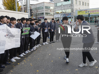 Nov 14, 2019 - Sangju, South Korea-A Group of High Schoolers cheer up for their senior group at entrance gate of Sangju high school in Sangj...