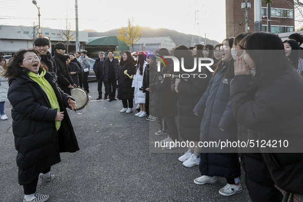 Nov 14, 2019 - Sangju, South Korea-A Group of High Schoolers cheer up for their senior group at entrance gate of Sangju high school in Sangj...