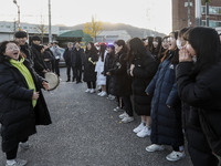 Nov 14, 2019 - Sangju, South Korea-A Group of High Schoolers cheer up for their senior group at entrance gate of Sangju high school in Sangj...