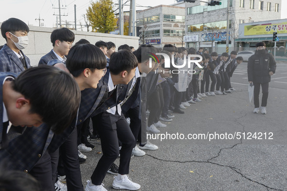 Nov 14, 2019 - Sangju, South Korea-A Group of High Schoolers cheer up for their senior group at entrance gate of Sangju high school in Sangj...