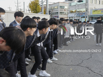 Nov 14, 2019 - Sangju, South Korea-A Group of High Schoolers cheer up for their senior group at entrance gate of Sangju high school in Sangj...