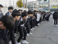 Nov 14, 2019 - Sangju, South Korea-A Group of High Schoolers cheer up for their senior group at entrance gate of Sangju high school in Sangj...