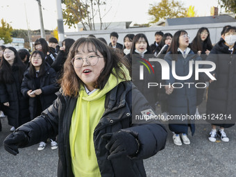 Nov 14, 2019 - Sangju, South Korea-A Group of High Schoolers cheer up for their senior group at entrance gate of Sangju high school in Sangj...