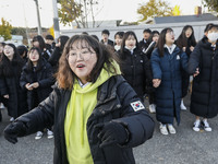 Nov 14, 2019 - Sangju, South Korea-A Group of High Schoolers cheer up for their senior group at entrance gate of Sangju high school in Sangj...