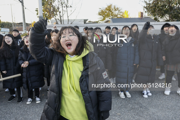 Nov 14, 2019 - Sangju, South Korea-A Group of High Schoolers cheer up for their senior group at entrance gate of Sangju high school in Sangj...