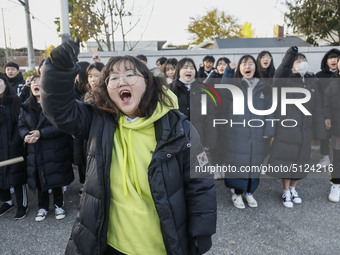 Nov 14, 2019 - Sangju, South Korea-A Group of High Schoolers cheer up for their senior group at entrance gate of Sangju high school in Sangj...