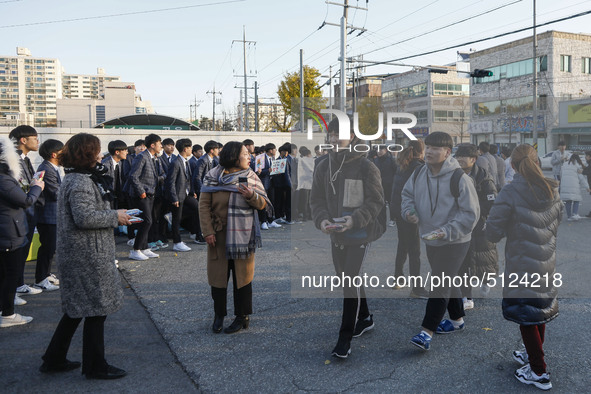 Nov 14, 2019 - Sangju, South Korea-A Group of High Schoolers cheer up for their senior group at entrance gate of Sangju high school in Sangj...