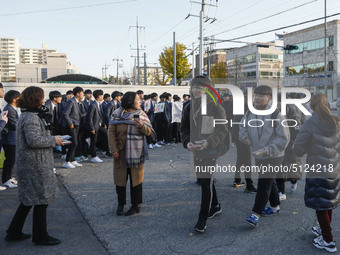 Nov 14, 2019 - Sangju, South Korea-A Group of High Schoolers cheer up for their senior group at entrance gate of Sangju high school in Sangj...