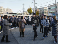 Nov 14, 2019 - Sangju, South Korea-A Group of High Schoolers cheer up for their senior group at entrance gate of Sangju high school in Sangj...