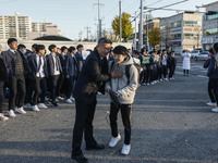 Nov 14, 2019 - Sangju, South Korea-A Group of High Schoolers cheer up for their senior group at entrance gate of Sangju high school in Sangj...