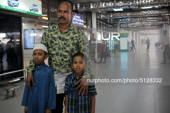 Nurul  Islam along with his two kids seen waiting to receive his wife Sumi Akter at Hazrat Shahjalal International Airport in Dhaka, Banglad...