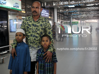 Nurul  Islam along with his two kids seen waiting to receive his wife Sumi Akter at Hazrat Shahjalal International Airport in Dhaka, Banglad...