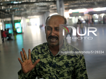 Nurul Islam seen reacting while talking with journalists as he waits to receive his wife Sumi Akter at Hazrat Shahjalal International Airpor...