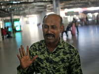 Nurul Islam seen reacting while talking with journalists as he waits to receive his wife Sumi Akter at Hazrat Shahjalal International Airpor...