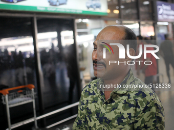 Nurul Islam seen reacting while talking with journalists as he waits to receive his wife Sumi Akter at Hazrat Shahjalal International Airpor...