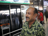 Nurul Islam seen reacting while talking with journalists as he waits to receive his wife Sumi Akter at Hazrat Shahjalal International Airpor...