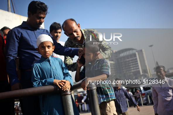 Nurul Islam and his children seen talking over phone with Sumi Akter as they are waiting to receive her at Hazrat Shahjalal International Ai...