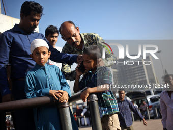 Nurul Islam and his children seen talking over phone with Sumi Akter as they are waiting to receive her at Hazrat Shahjalal International Ai...