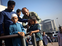 Nurul Islam and his children seen talking over phone with Sumi Akter as they are waiting to receive her at Hazrat Shahjalal International Ai...