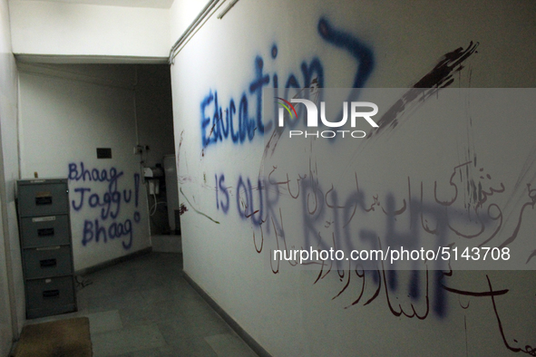 A view of an anti-administration slogan painted by the protesting students who are demanding the roll back of the hostel fee hike, at Jawaha...