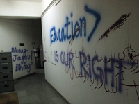 A view of an anti-administration slogan painted by the protesting students who are demanding the roll back of the hostel fee hike, at Jawaha...