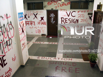 A view of an anti-administration slogan painted by the protesting students who are demanding the roll back of the hostel fee hike, at Jawaha...