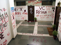 A view of an anti-administration slogan painted by the protesting students who are demanding the roll back of the hostel fee hike, at Jawaha...