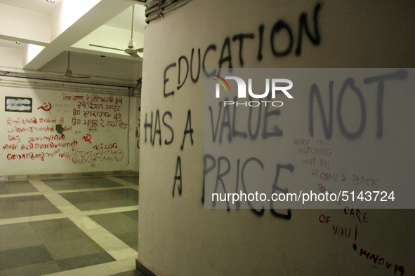 A view of an anti-administration slogan painted by the protesting students who are demanding the roll back of the hostel fee hike, at Jawaha...