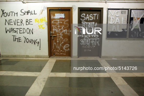 A view of an anti-administration slogan painted by the protesting students who are demanding the roll back of the hostel fee hike, at Jawaha...