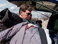 Volunteer helping taking out the clothes from the pastor's car. On April 6 2015, we visit Krasnogorovka. What we saw is the evident beginnin...