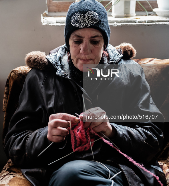 Lira, 47 years old while waiting for the communial meal. She leave alone and like so many others, rely only on humanitarian aid to be able t...