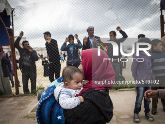 A Syrian Kurdish refugee and her child arrive in Kobane, Syria, April 3, 2015. Some Syrian refugees who fled to Turkey returned to Kobane af...