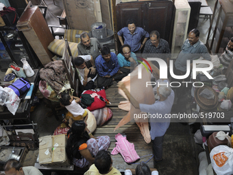 Ayub Mallik (M) who has been working at the Russell Exchange for more than 25 years showing old clothes to the buyers during the old clothes...