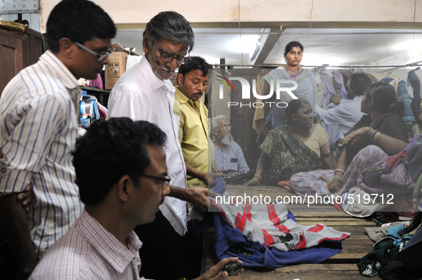 Customers seeing and biding for old clothes during the old clothes auction at The Russell Exchange on thursday 2nd April , 2015 in Kolkata,...