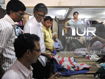 Customers seeing and biding for old clothes during the old clothes auction at The Russell Exchange on thursday 2nd April , 2015 in Kolkata,...