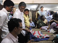 Customers seeing and biding for old clothes during the old clothes auction at The Russell Exchange on thursday 2nd April , 2015 in Kolkata,...