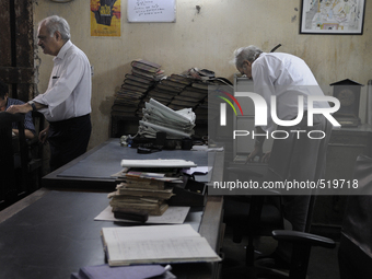 Arshad  Saleem (Left) and Anwar Saleem (Right) - two brothers who runs The Russell Exchange during the old clothes auction at The Russell Ex...