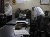 Arshad  Saleem (Left) and Anwar Saleem (Right) - two brothers who runs The Russell Exchange during the old clothes auction at The Russell Ex...